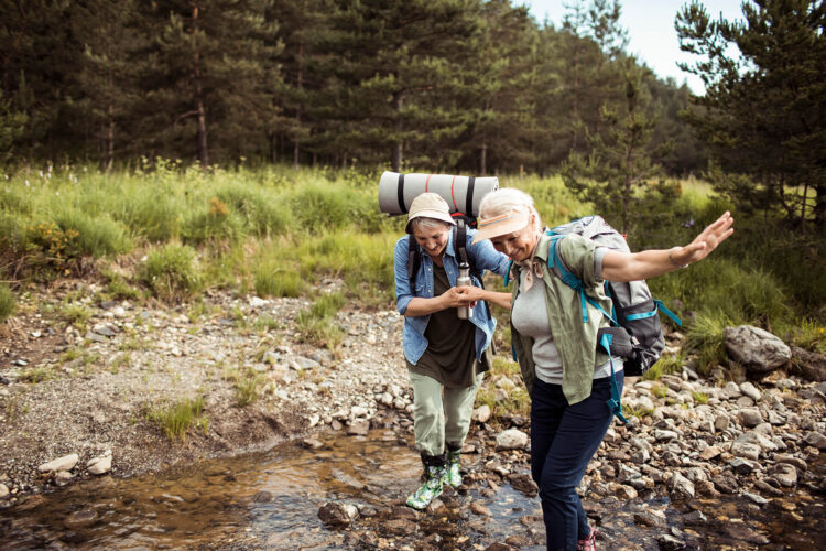 Two senior female friends hiking together
